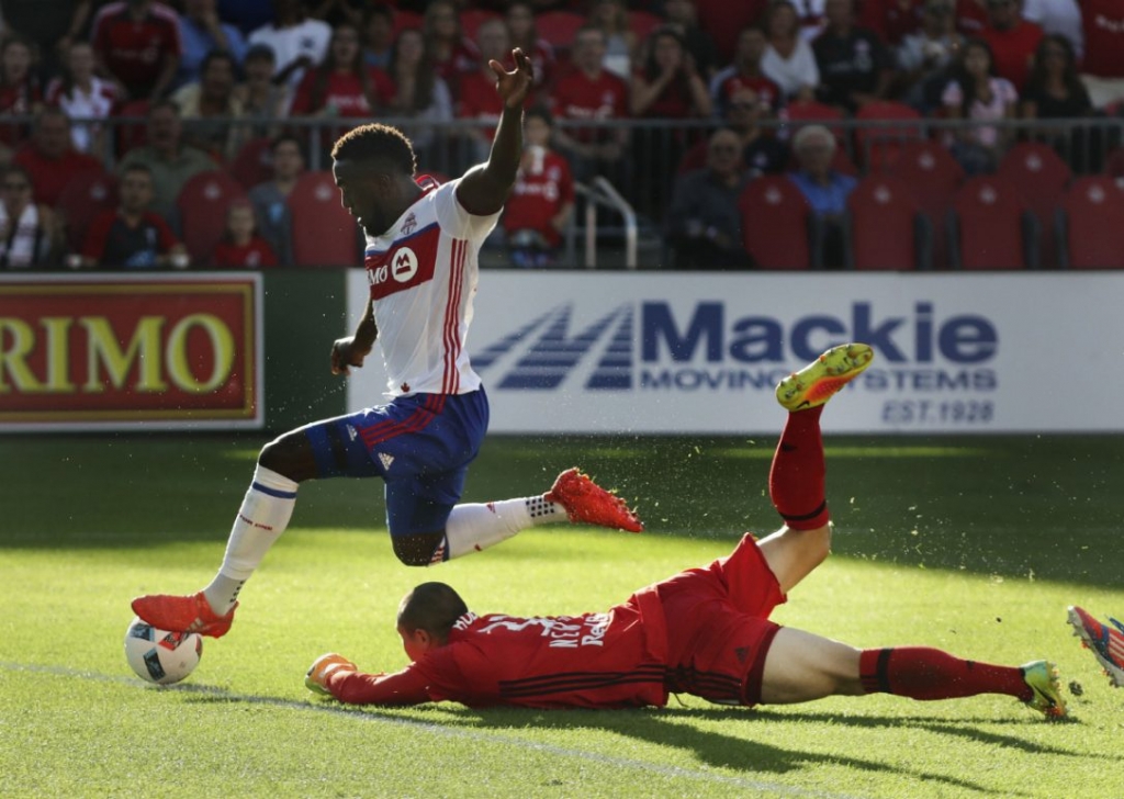 Toronto FC forward Jozy Altidore who scored twice on Sunday hurdles Red Bulls goalkeeper Luis Robles at BMO Field