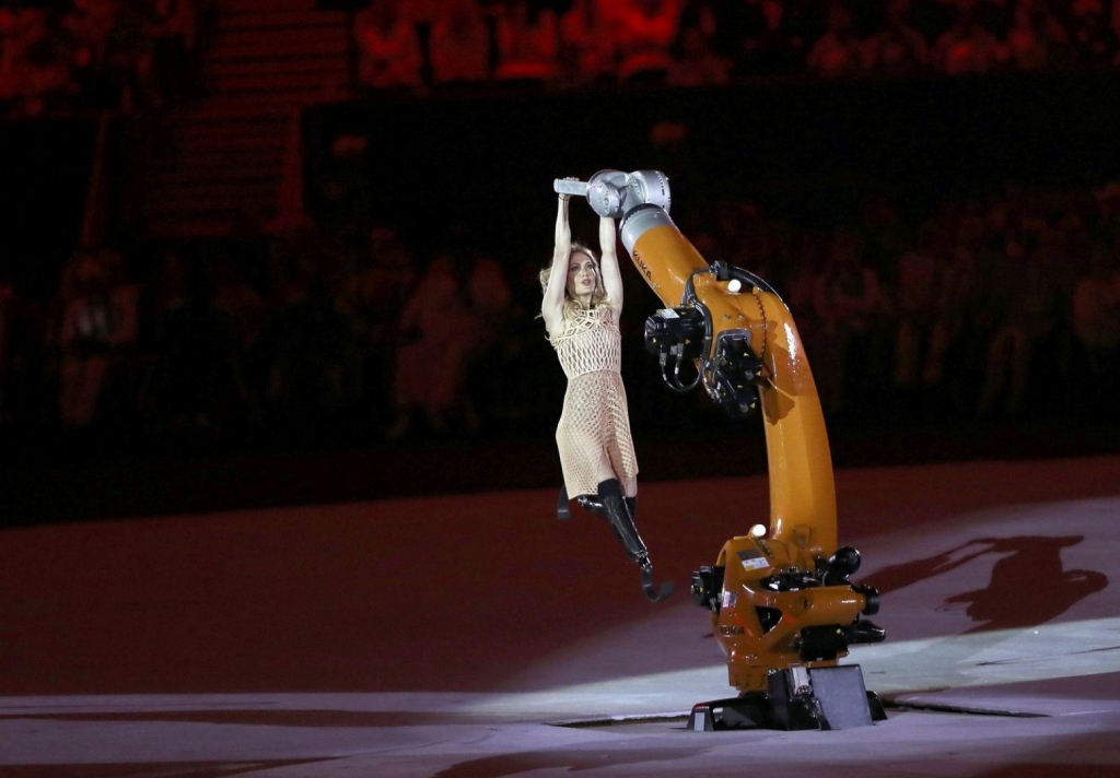 American snowboarder Amy Purdy dancing alongside a robotic arm