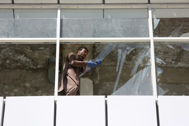 An Afghan man cleans up broken glass near the site of suicide attack in Kabul Afghanistan Tuesday Sept. 6 2016