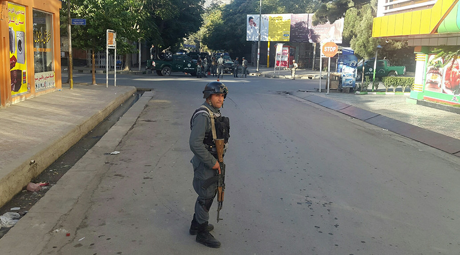 An Afghan policeman stands guard near the site of an attack in Kabul Afghanistan