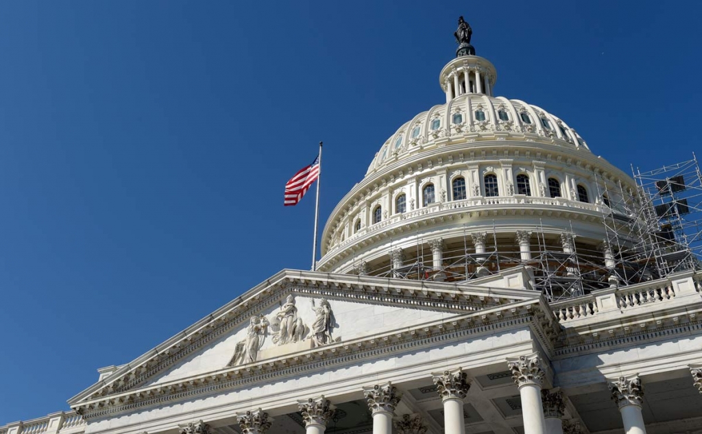 An American flag flies over Capitol Hill in Washington Tuesday Sept. 6 2016 as lawmakers return from a 7-week break