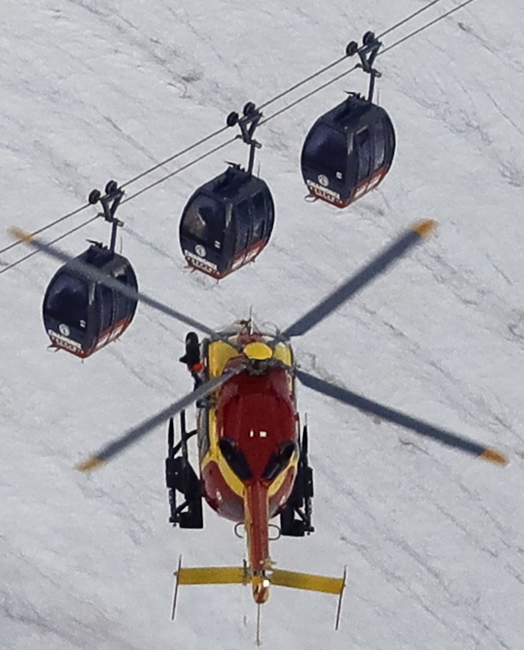 An EC-135 helicopter going to rescue passengers trapped in stalled cable cars in Mont Blanc