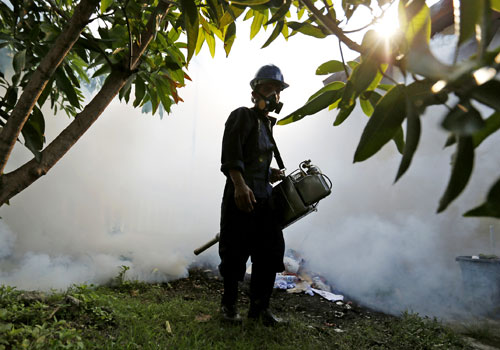 An Indonesian health worker sprays pesticide to prevent the spread of mosquito-borne illnesses such as the Zika virus in Banda Aceh