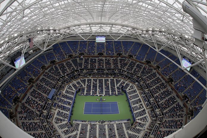 Simona Halep of Romania serves to Lucie Safarova of the Czech Republic during the second round of the U.S. Open tennis tournament Thursday Sept. 1 in New York. Despite rain falling outside Arthur Ashe Stadium the new roof was closed to allow play