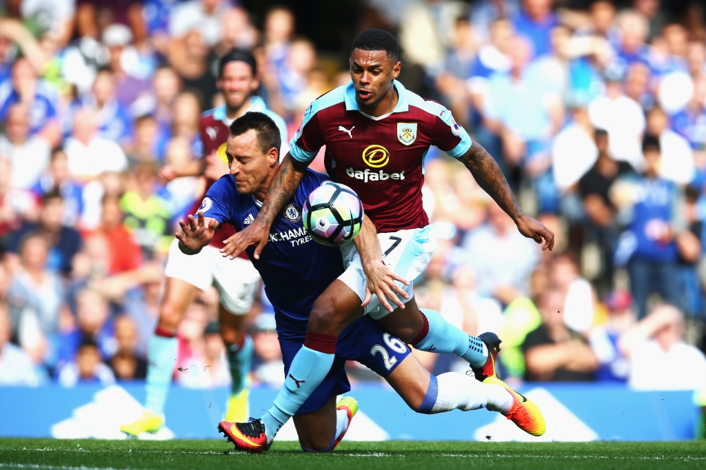 LONDON ENGLAND- AUGUST 27 John Terry of Chelsea and Andre Gray of Burnley battle for possession during the Premier League match between Chelsea and Burnley at Stamford Bridge