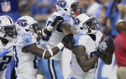 Tennessee Titans wide receiver Andre Johnson right prepares to toss the ball into the stands after his touchdown during the second half of an NFL football game against the Detroit Lions Sunday Sept. 18 2016 in Detroit. The Titans defeated the Lions