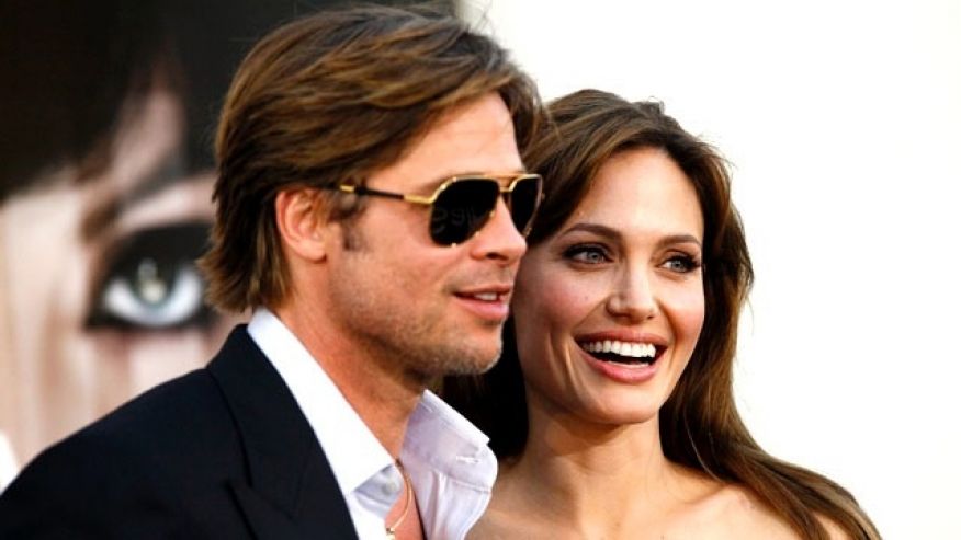 Angelina Jolie and actor Brad Pitt pose at the premiere of'Salt in Hollywood California