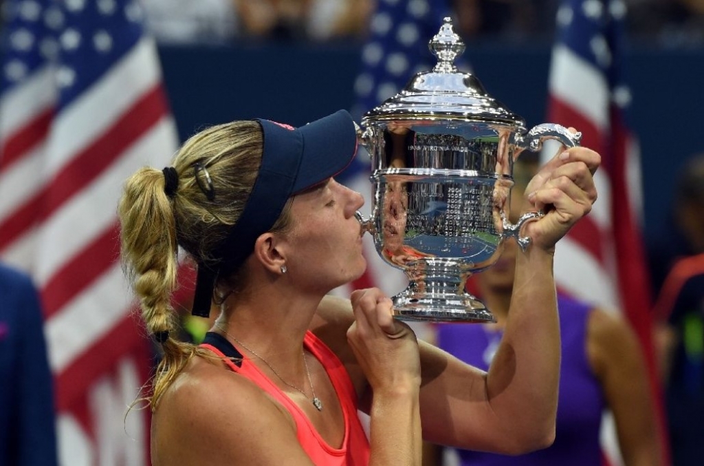 Angelique Kerber of Germany kisses her winning trophy after defeating Karolina Pliskova of Czech Republic