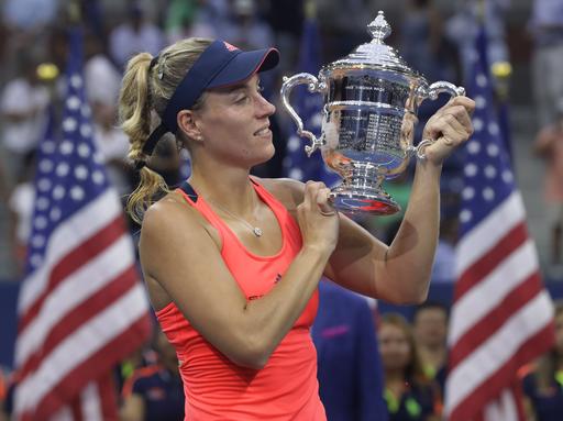 Angelique Kerber of Germany holds up the championship trophy after beating Karolina Pliskova