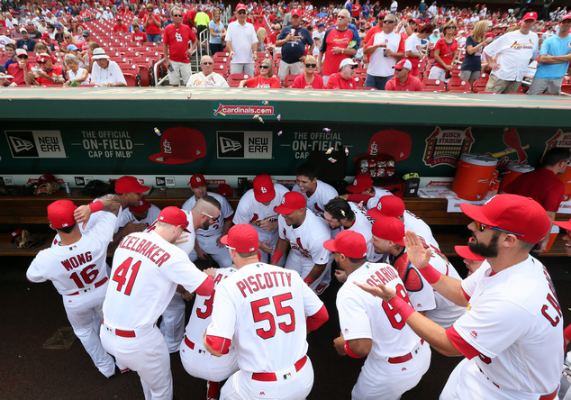 St. Louis Cardinals players gather in dugout for a team cheer before a baseball a game between the Chicago Cubs Wednesday Sept. 14 2016 at Busch Stadium