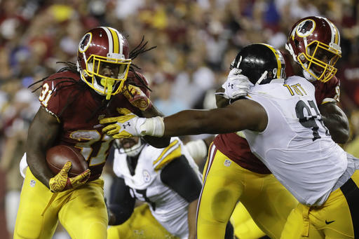 Washington Redskins running back Matt Jones runs past the reach of Pittsburgh Steelers defensive end Stephon Tuitt during the first half of an NFL football game in Landover Md. Monday Sept. 12 2016