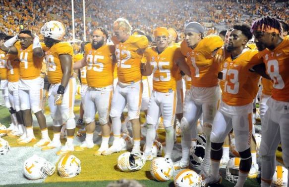 Tennessee players stand arm-in-arm after the game against Appalachian State at Neyland Stadium on Thursday