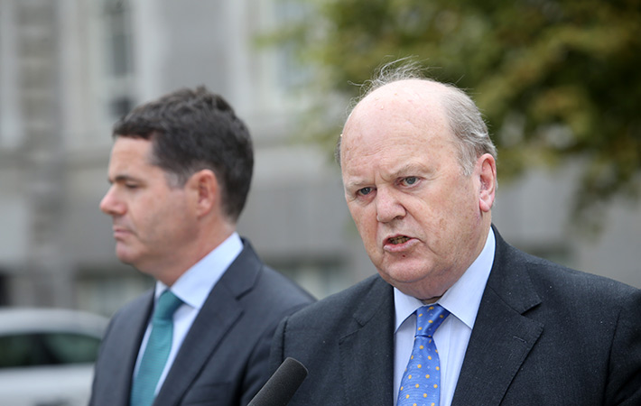 Irish Finance Minister Michael Noonan and the Minister for Public Expenditure and Reform Paschal Donohoe speaking to reporters after the special cabinet meeting at Government Buildings in Dublin ear