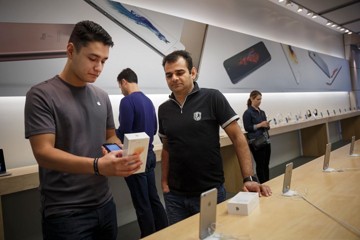 Apple store employee Cristian Zuniga sells the new iPhone 6s