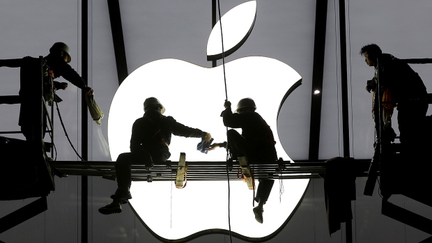 Workers prepare for the opening of an Apple store in China. Despite its world domination as of 2015 the American company held $187 billion US outside the U.S