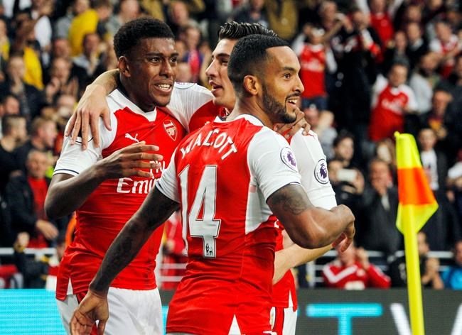 Arsenal's Theo Walcott front celebrates scoring his side's second goal with teammates Alex Iwobi left and Hector Bellerin during their English Premier League soccer match against Hull at the KCOM Stadium Hull England Saturday Sept. 17 201