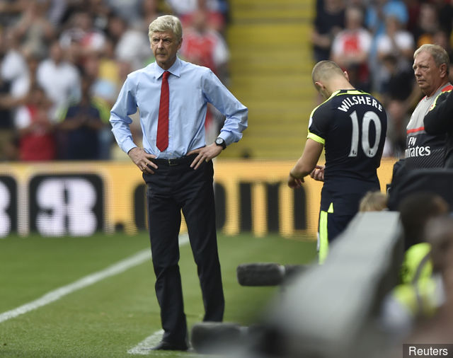 Arsenal's Jack Wilshere waits to come on as manager Arsene Wenger looks