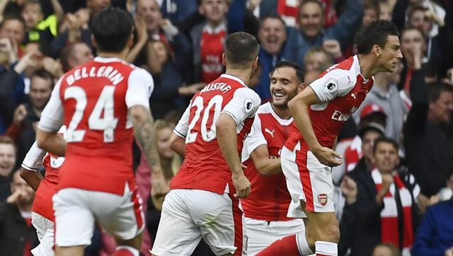 Arsenal's Laurent Koscielny celebrates scoring their first goal with teammates