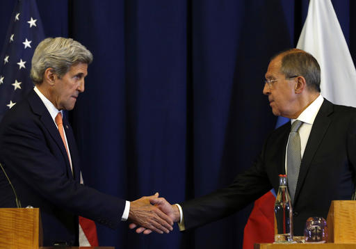 U.S. Secretary of State John Kerry left and Russian Foreign Minister Sergei Lavrov shakes hands at the conclusion of a news conference following their meeting to discuss the crisis