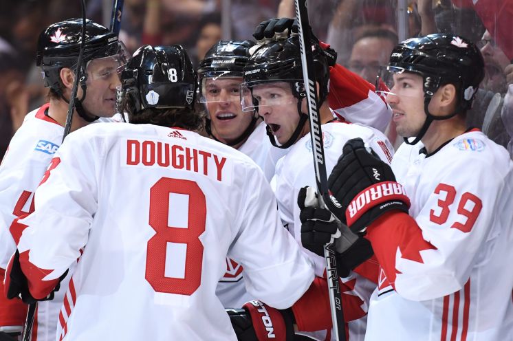 Canada’s Corey Perry second right celebrates his first-period goal with teammates against Team USA