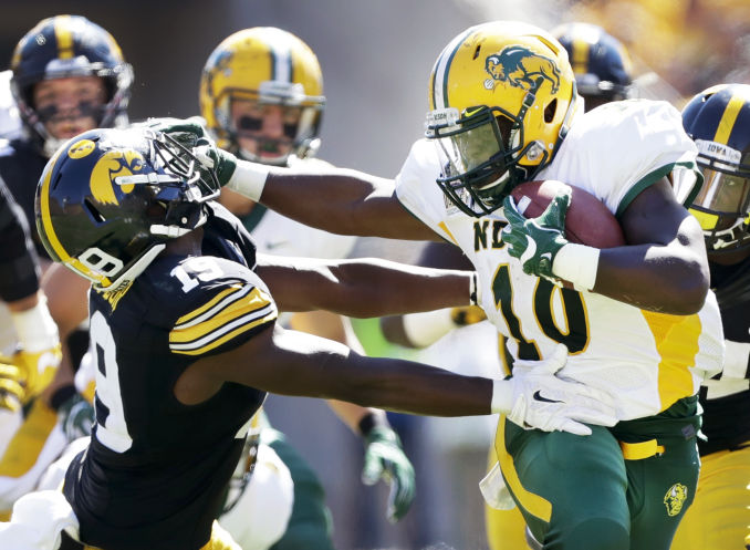 North Dakota State running back Lance Dunn stiff arms Iowa defensive back Miles Taylor in the second half