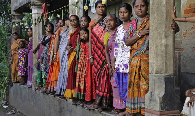 Villagers wait on a verandah to witness the funeral procession of Indian army soldier Gangadhar Dalai who was killed in a militant attack in Uri Kashmir in Jamuna Balia village west of Kolkata India Tuesday Sept. 20 2016. Early Sunday fighters