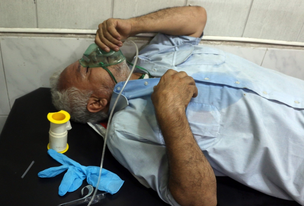 A Syrian man suffering from breathing difficulties is treated at a make-shift hospital in Aleppo after regime helicopters dropped barrel bombs on the rebel-held Sukkari neighbourhood of the northern Syrian city