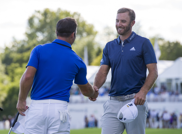 Dustin Johnson right is congratulated by Paul Casey of England on the 18th green after winning the BMW Championship golf tournament at Crooked Stick Golf