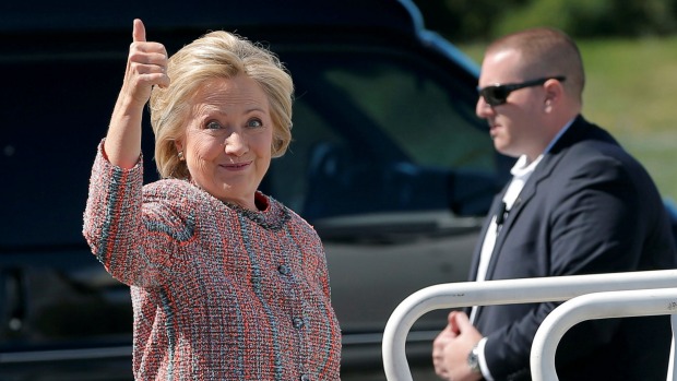 U.S. Democratic presidential candidate Hillary Clinton gives a thumbs up as she boards her campaign plane