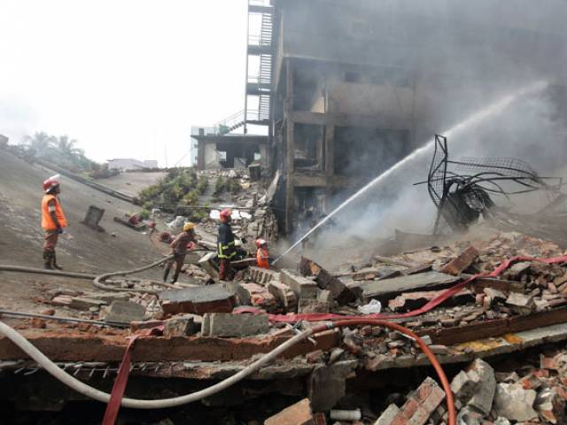 Bangladeshi firefighters try to extinguish a fire that break out from an explosion in a factory in the key Bangladeshi garment manufacturing town of Tongi just north of the capital Dhaka