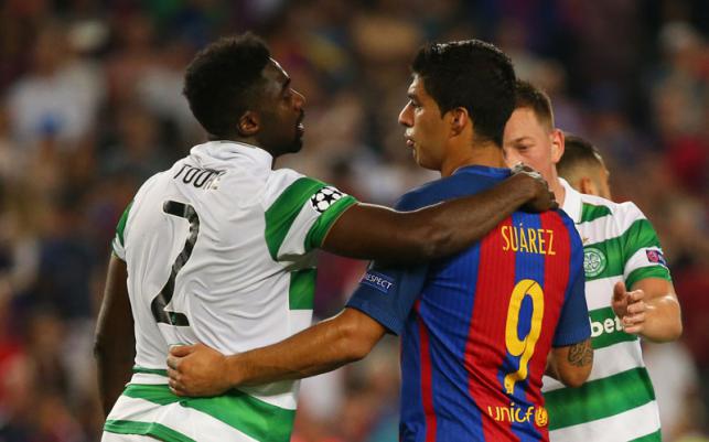 Celtic`s Kolo Toure with Barcelona`s Luis Suarez at the end of the game