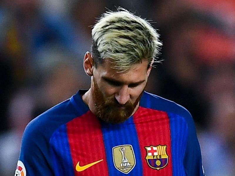 BARCELONA SPAIN- SEPTEMBER 21 Lionel Messi of FC Barcelona reacts injured on the pitch during the La Liga match between FC Barcelona and Club Atletico de Madrid at the Camp Nou stadium