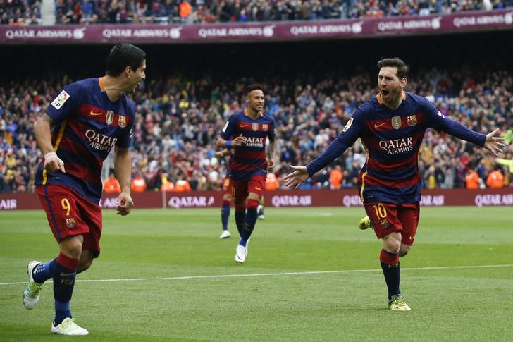 Barcelona's Lionel Messi celebrates his first goal with team mates Luis Suarez and