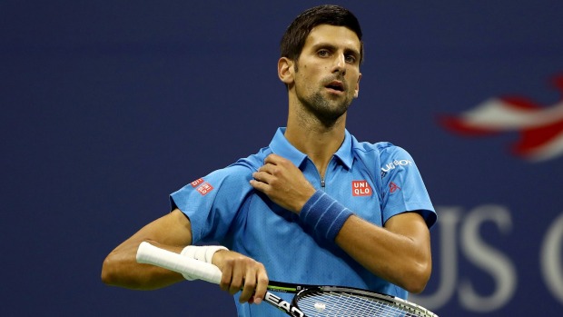 Novak Djokovic struggled with an arm injury before beating Jerzy Janowicz of Poland during his first round singles match