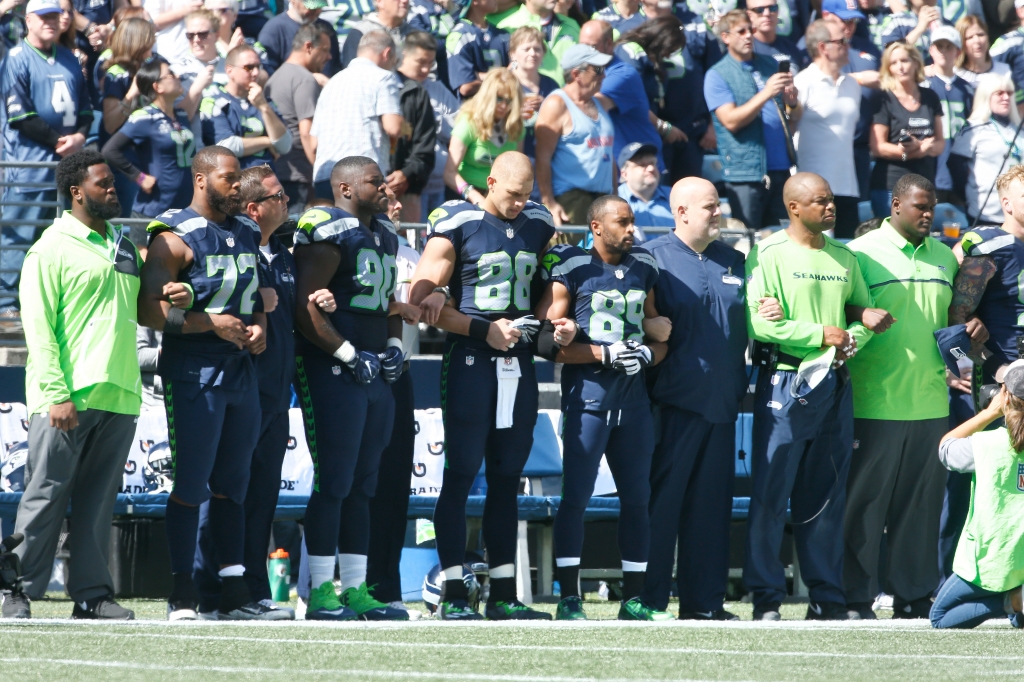 SEATTLE WA- SEPTEMBER 11 Members of the Seattle Seahawks are seen together during the playing of the National Anthem before the start of an NFL game against the Miami Dolphins at Century Link Field