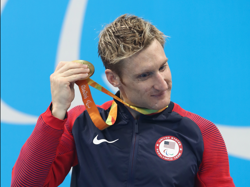 Blind swimmer Bradley Snyder shakes his gold medal on the podium at the Rio Games.   Getty Images  Buda Mendes