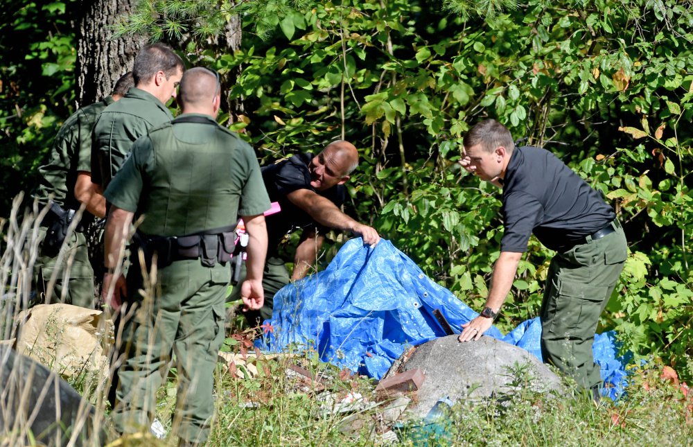 Police look for evidence in the death of Valerie Tieman whose body was found in the woods behind her home in Fairfield on Tuesday. Staff