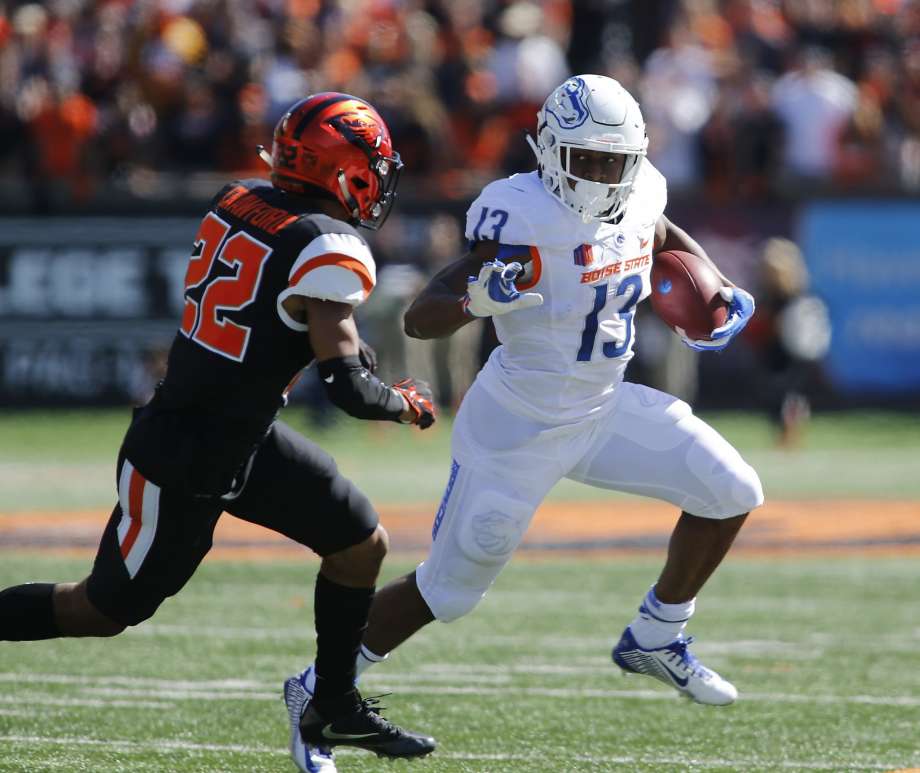 Boise State running back Jeremy Mc Nichos zips past Oregon State’s Xavier Crawford for some of his 208 yards