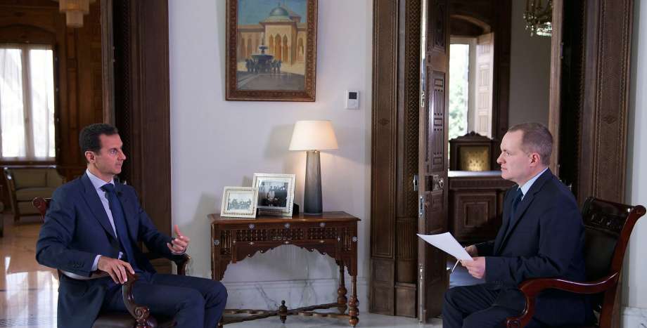 President Bashar Assad speaks with Ian Phillips the Associated Press’ vice president for international news at the presidential palace in Damascus