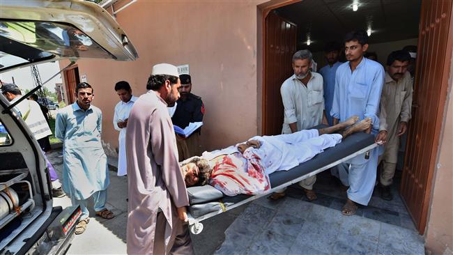 Pakistani volunteers transport an injured blast victim at a hospital following a bomb attack at a district court in Mardan