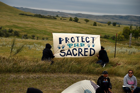 People hang a sign near a burial ground sacred site that was disturbed by bulldozers building the Dakota Access Pipeline, near the encampment where hundreds of people have gathered to join the Standing Rock Sioux Tribe's protest of the oil pip