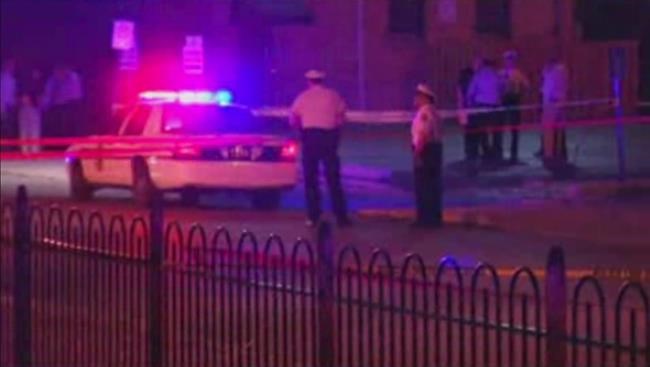 In this frame from video police work at the scene of a shooting on Wednesday Sept. 14 2016 in Columbus Ohio. Police in Ohio responding to a report of an armed robbery shot and killed a boy who they said pulled a gun from his waistband that was later