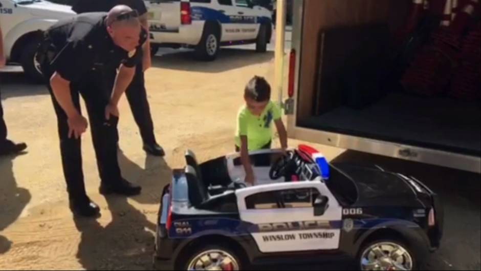 Police surprise boy who bought them lunch with mini police cruiser