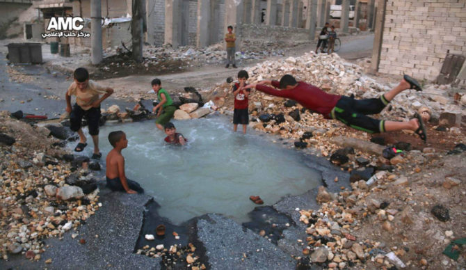 Boys Swim In Bomb Crater During Syrian Ceasefire