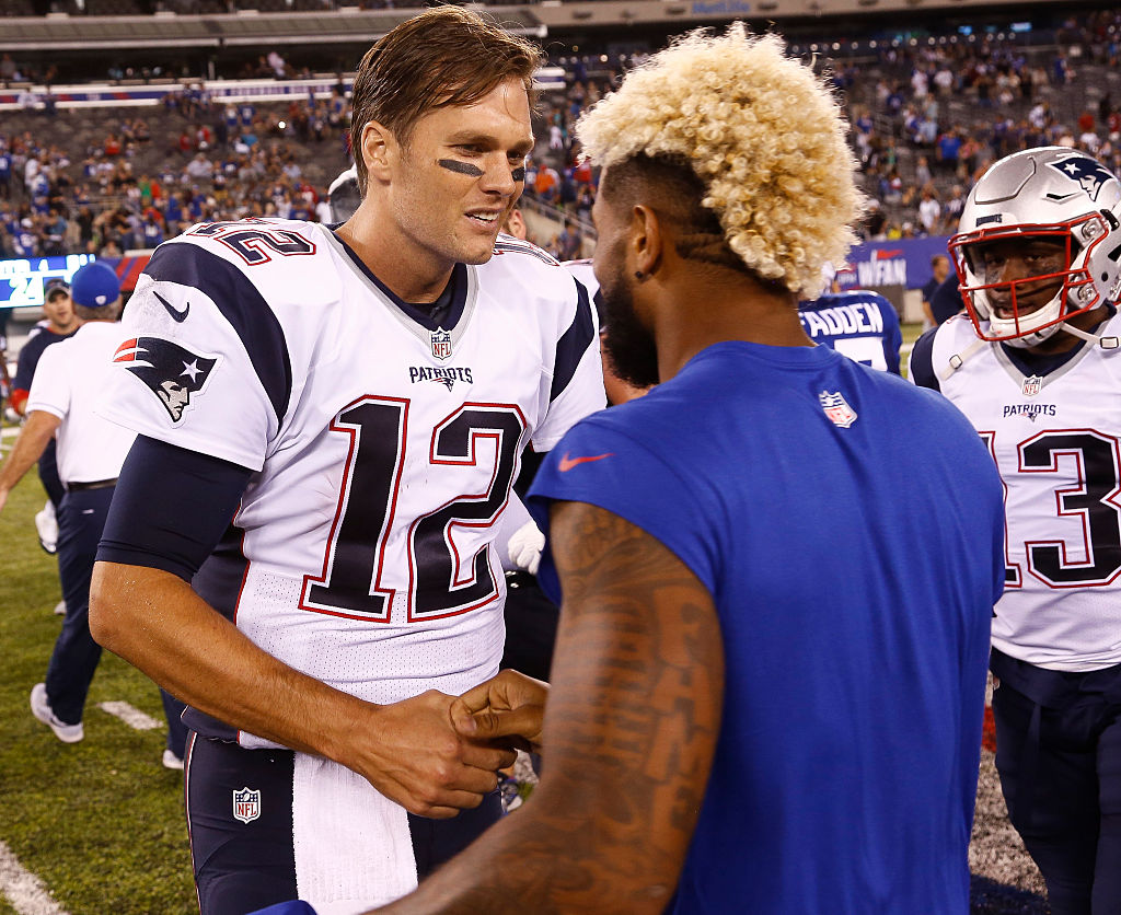 Tom Brady #12 of the New England Patriots talks with Odell Beckham #13 of the New York Giants during a preseason game at Met Life Stadium