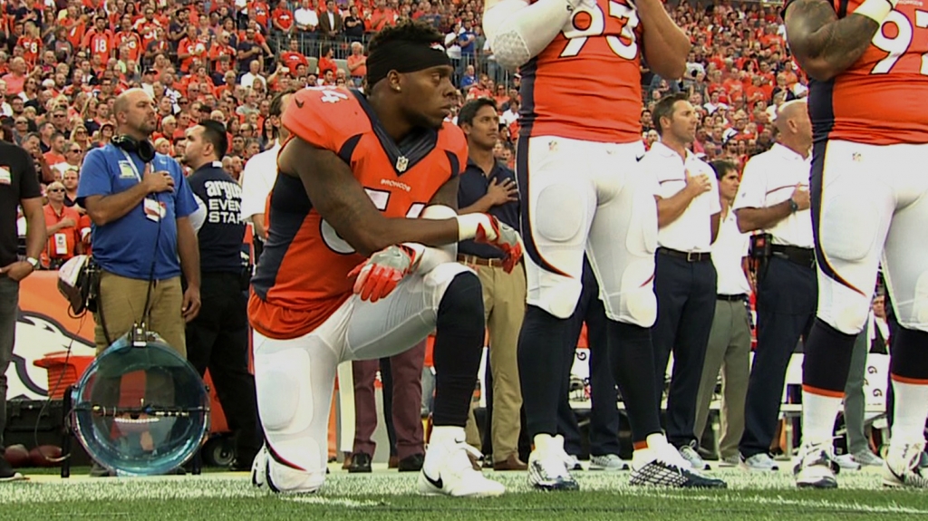 Brandon Marshall kneels during the national anthem prior to NFL opener