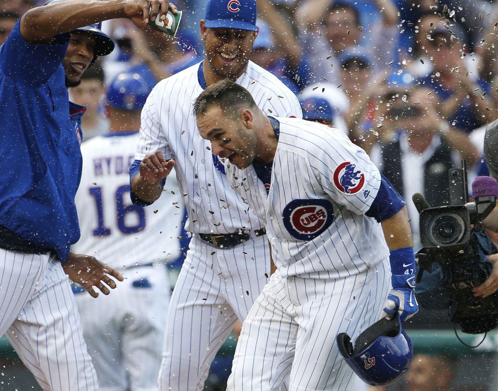 Chicago Cubs Miguel Montero right celebrates with teammates after hitting a solo home run against the Milwaukee Brewers during the 10th inning of a baseball game Friday Sept. 16 2016 in Chicago. The Cubs won 5-4