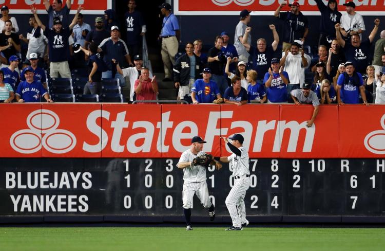 Brett Gardner celebrates his outstanding catch with Yankees teammate Jacoby Ellsbury