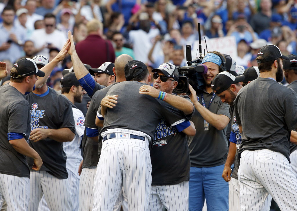 Cubs manager Joe Maddon hugs Kris Bryant in the post-game celebration of the Cubs&#039 National League Central title Friday at Wrigley Field. The Cubs are 191-114 in two seasons under Maddon