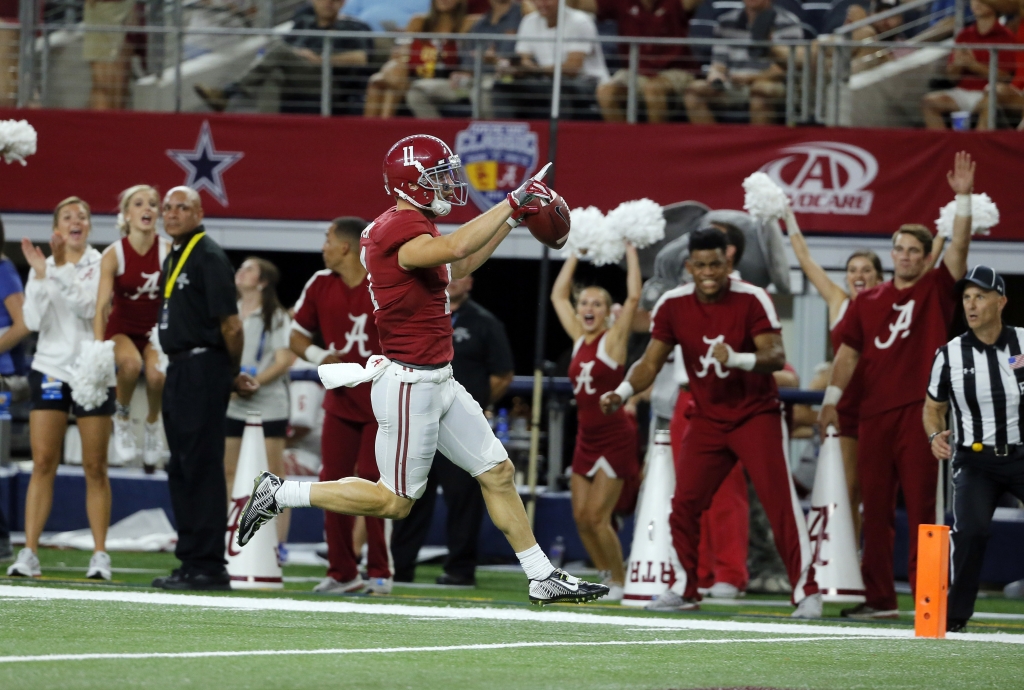 Alabama wide receiver Gehrig Dieter celebrates as he crosses into the end zone after catching a pass and running it in for a touchdown during the second half of an NCAA college football game against Southern California Saturday Sept. 3 2016 in Arlingto